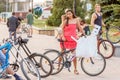 beautiful, elegant, ornate participant in the carnival costumed women`s bike ride in the summer evening