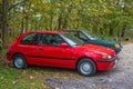 Classic elegant red old Mazda 323 parked