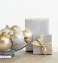 Beautiful, elegant silver and gold Christmas gifts and glass bowl with baubles ornaments. Fancy, luxury holiday home decor