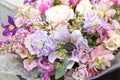 Beautiful pink purple violet bouquet by florist with different flowers and roses close-up, macro. Floral background