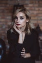 Beautiful elegant woman blonde in a black dress with feathers in retro style 1920 fashion. Soft selective focus Royalty Free Stock Photo