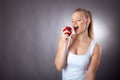 beautiful and elegant woman eats an Apple