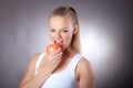 Beautiful and elegant woman eats an Apple