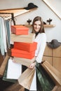 beautiful elegant woman holding shopping bags and shoe boxes