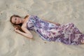 Beautiful elegant woman lies on sand Royalty Free Stock Photo