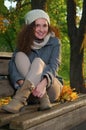 Beautiful elegant woman in a park in autumn