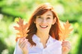 Beautiful elegant woman standing in a park in autumn. Beautiful girl walking outdoors in autumn. Smiling girl collects