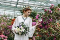 beautiful elegant young bride holding wedding bouquet and touching flowers Royalty Free Stock Photo