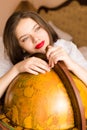 Beautiful elegant young woman attractive brunette female student happy smiling with red lipstick at the globe looking up Royalty Free Stock Photo