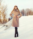 Beautiful elegant young woman wearing a coat and sunglasses in winter Royalty Free Stock Photo