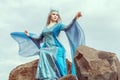 Beautiful elf woman sits on top of a mountain. Royalty Free Stock Photo