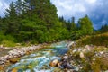 emerald mountain river rushing among green valley Royalty Free Stock Photo