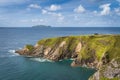 Beautiful emerald water of Atlantic Ocean and tall cliffs near Dunquin Pier, Dingle