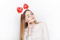 Beautiful emotional blonde female model wear santa deer headpiece. Christmas greetings concept. Royalty Free Stock Photo