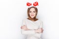 Beautiful emotional blonde female model wear santa deer headpiece. Christmas greetings concept. Royalty Free Stock Photo