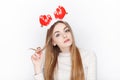 Beautiful emotional blonde female model wear santa deer headpiece. Christmas greetings concept. Royalty Free Stock Photo