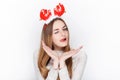 Beautiful emotional blonde female model wear santa deer headpiece. Christmas greetings concept. Royalty Free Stock Photo