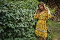 Beautiful emotional outdoor portrait of young woman in yellow dress.