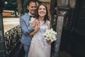 Beautiful emotional wedding couple laughing and hugging in european city. Provence wedding. Stylish happy bride and groom smiling Royalty Free Stock Photo