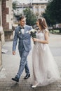 Beautiful emotional wedding couple smiling and walking in european city. Provence wedding. Stylish happy bride and groom walking Royalty Free Stock Photo