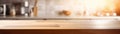 Beautiful empty brown wooden table top with the background blurred defocused of a modern kitchen interior with daylight flare and Royalty Free Stock Photo