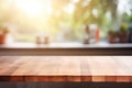 Beautiful empty brown wooden table top and blurred defocused modern kitchen interior background with daylight flare, product Royalty Free Stock Photo