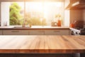 Beautiful empty brown wooden table top and blurred defocused modern kitchen interior background with daylight flare, product Royalty Free Stock Photo