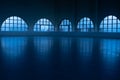 Beautiful empty dark skating rink illuminated with soft blue light. An ice arena with smooth, shiny ice surface and