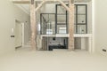 A beautiful empty loft with an old structure of wooden beams and pillars, Stairs made of polished white concrete with access to a