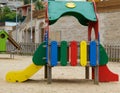 Beautiful empty park for children with a colorful small playground on the sand Royalty Free Stock Photo