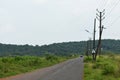 Beautiful Empty road in Autumn season with green fields and cloudy sky in Goa Royalty Free Stock Photo