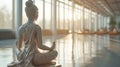 Beautiful, empty yoga studio with woman statue and sunlights