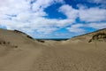 Beautiful endless sand dunes on the baltic sea coast under bright blue sky with clouds, Curonian Spit, Lithuania Royalty Free Stock Photo