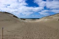 Beautiful endless sand dunes on the baltic sea coast under bright blue sky with clouds, Curonian Spit, Lithuania Royalty Free Stock Photo