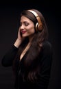 Beautiful enjoying long hair young woman listening the music in Royalty Free Stock Photo