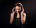 Beautiful enjoying young woman listening the music in wireless h Royalty Free Stock Photo