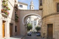 Beautiful entrance adorned with its pots of geraniums on the balconies to the Bocairent square, Valencia province, Spain