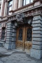 A beautiful entrance with dark stucco moldings and forged doors to one of the buildings in Odessa.