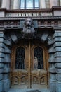 A beautiful entrance with dark stucco moldings and forged doors to one of the buildings in Odessa.