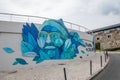 Beautiful entrance to the Cascais Marina, a blue face logo on the building