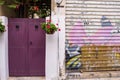 Beautiful entrance into the yard of a traditional house next to a garage door painted with graffitti in old Nicosia, Cyprus