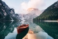 Beautiful environment. Wooden boat on the crystal lake with majestic mountain behind. Reflection in the water Royalty Free Stock Photo