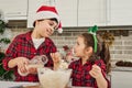 Beautiful European children enjoying time together, having fun while kneading dough, cooking cookies and bakeries, helping their Royalty Free Stock Photo