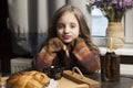 Beautiful European girl 10 years old. Sits at the table and smiles. Happy child Royalty Free Stock Photo