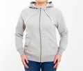 Beautiful european mid aged woman dressed in a light grey casual hooded jacket - studio shot in front of a white background Royalty Free Stock Photo