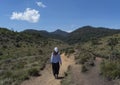 Beautiful european tourist girl walking a way to the mountains Royalty Free Stock Photo