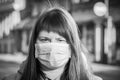 Beautiful European woman with a medical face mask on. Closeup of a female in a respirator to protect against coronavirus Royalty Free Stock Photo