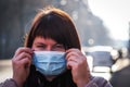Beautiful European woman with a medical face mask on. Closeup of a female in a respirator to protect against coronavirus Royalty Free Stock Photo