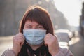 Beautiful European woman with a medical face mask on. Closeup of a female in a respirator to protect against coronavirus Royalty Free Stock Photo