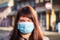 Beautiful European woman with a medical face mask on. Closeup of a female in a respirator to protect against coronavirus Royalty Free Stock Photo